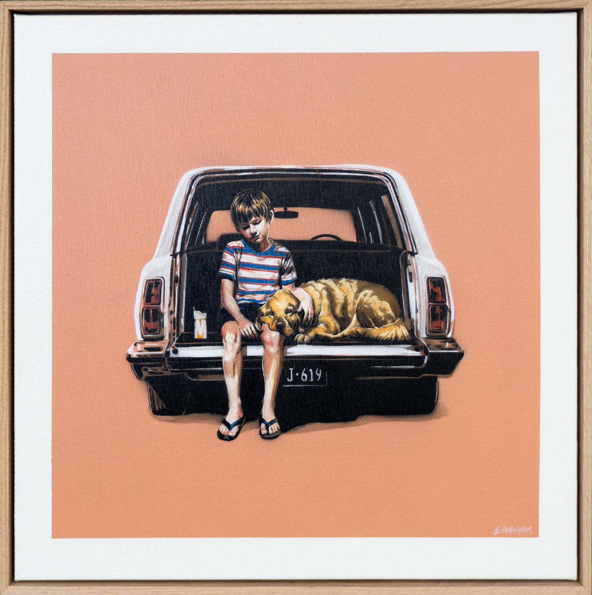 A framed original painting depicting a young boy sitting in the back of a white station wagon with a golden retriever dog resting on the tailgate, set against a solid peach background.