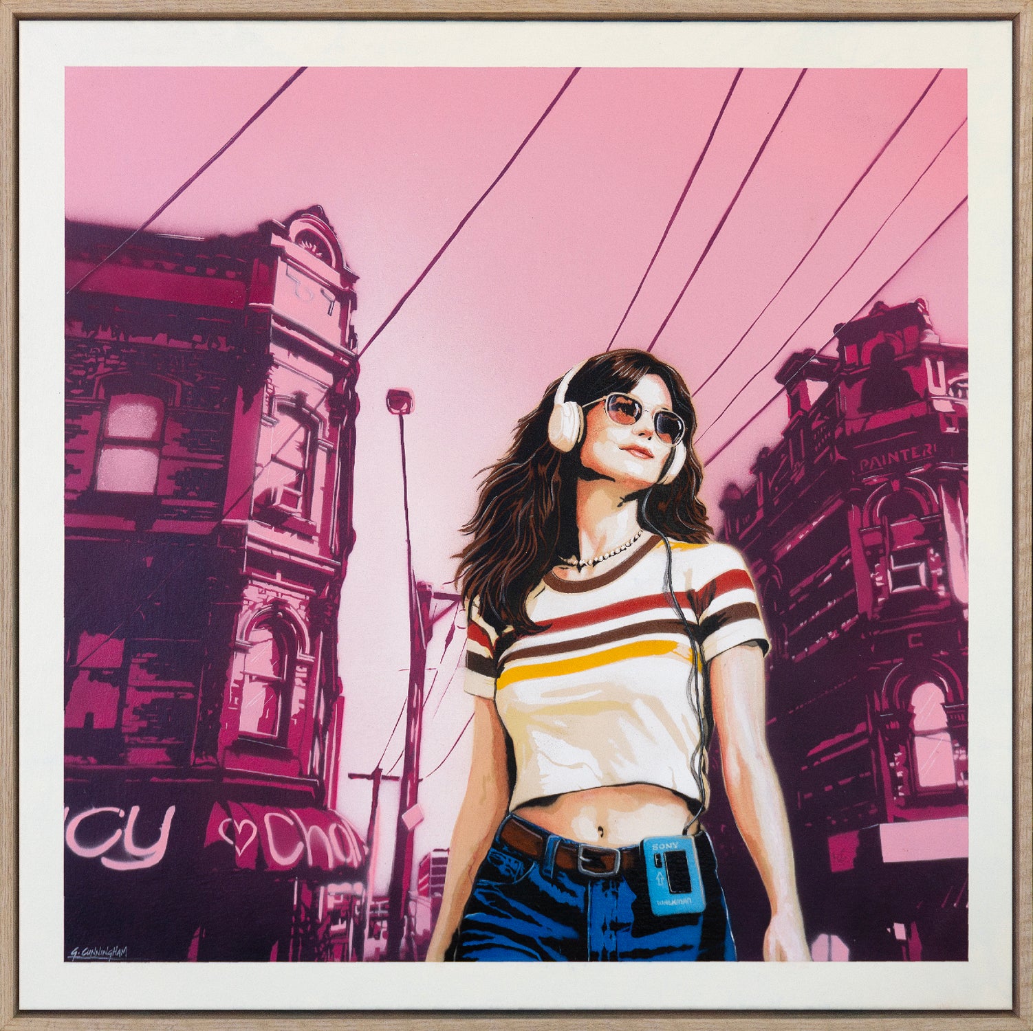 Framed artwork of a person with headphones against a stylized cityscape background.