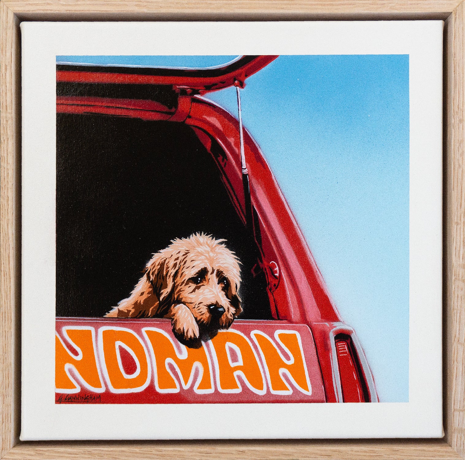 A scruffy dog waits in the ack of a sandman station wagon