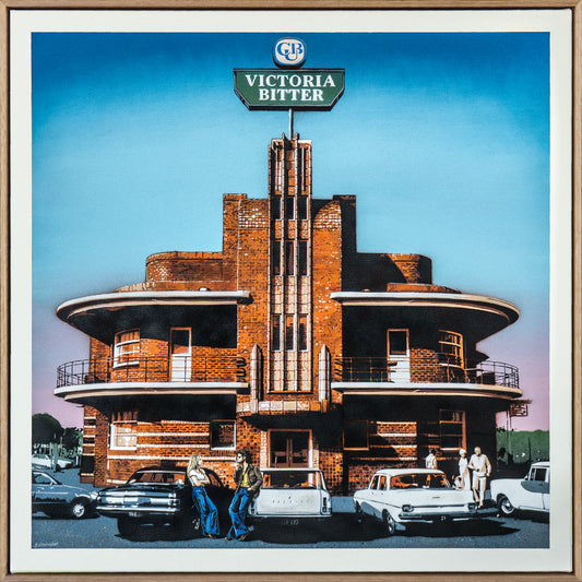 Art Deco-style building with 'Victoria Bitter' sign, vintage cars, and people in front.
